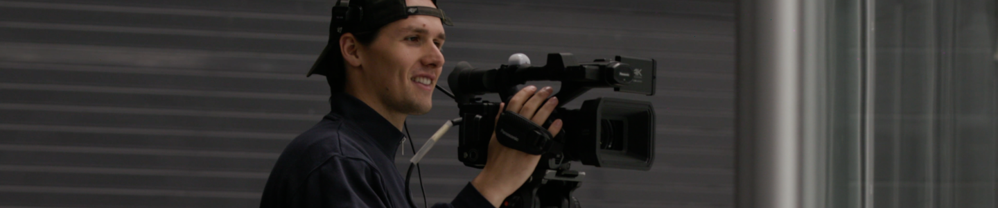 BrockTV producer operating a camera.