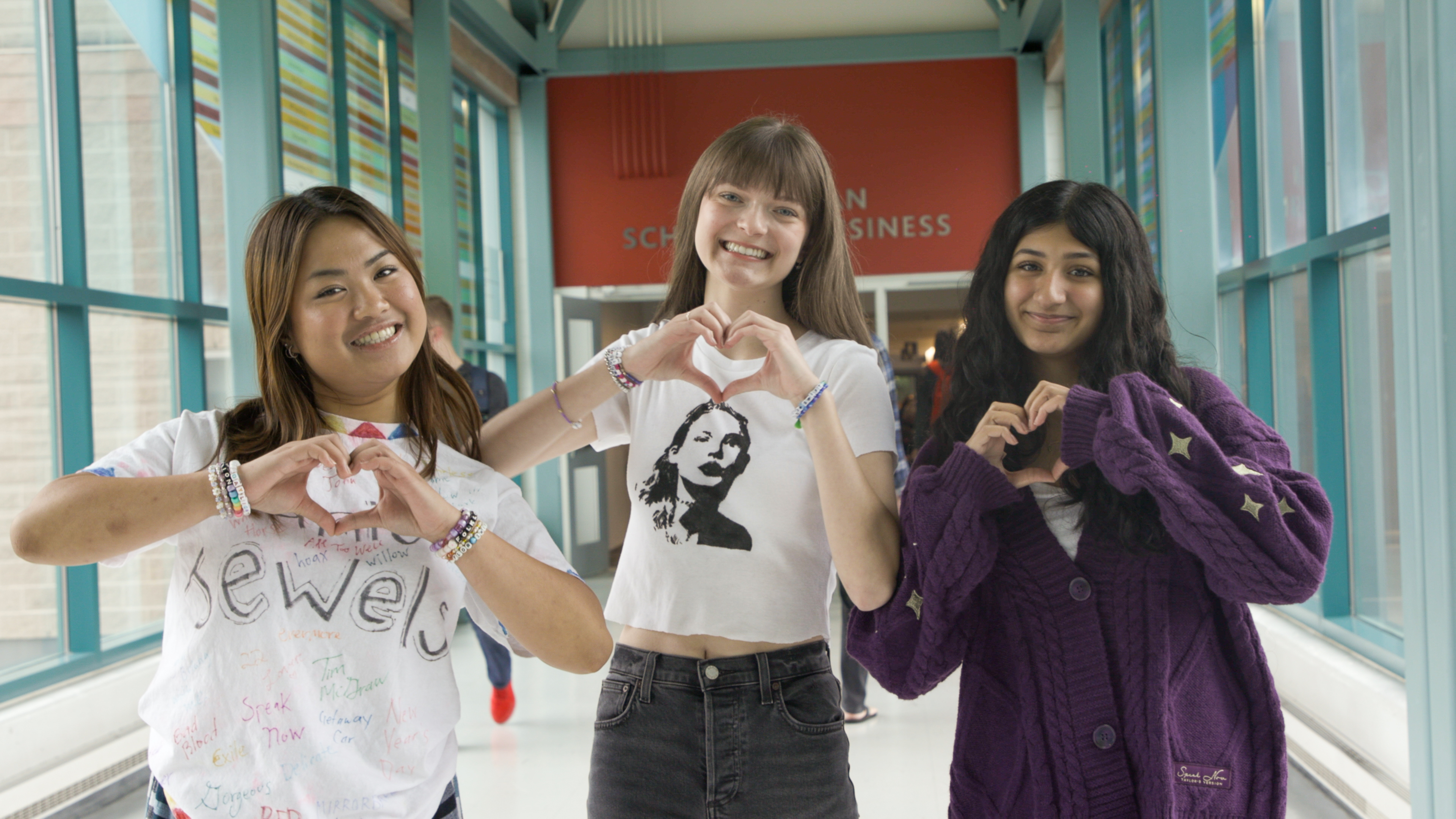 BUSU clubs students making heart hand gestures in Brock hallway