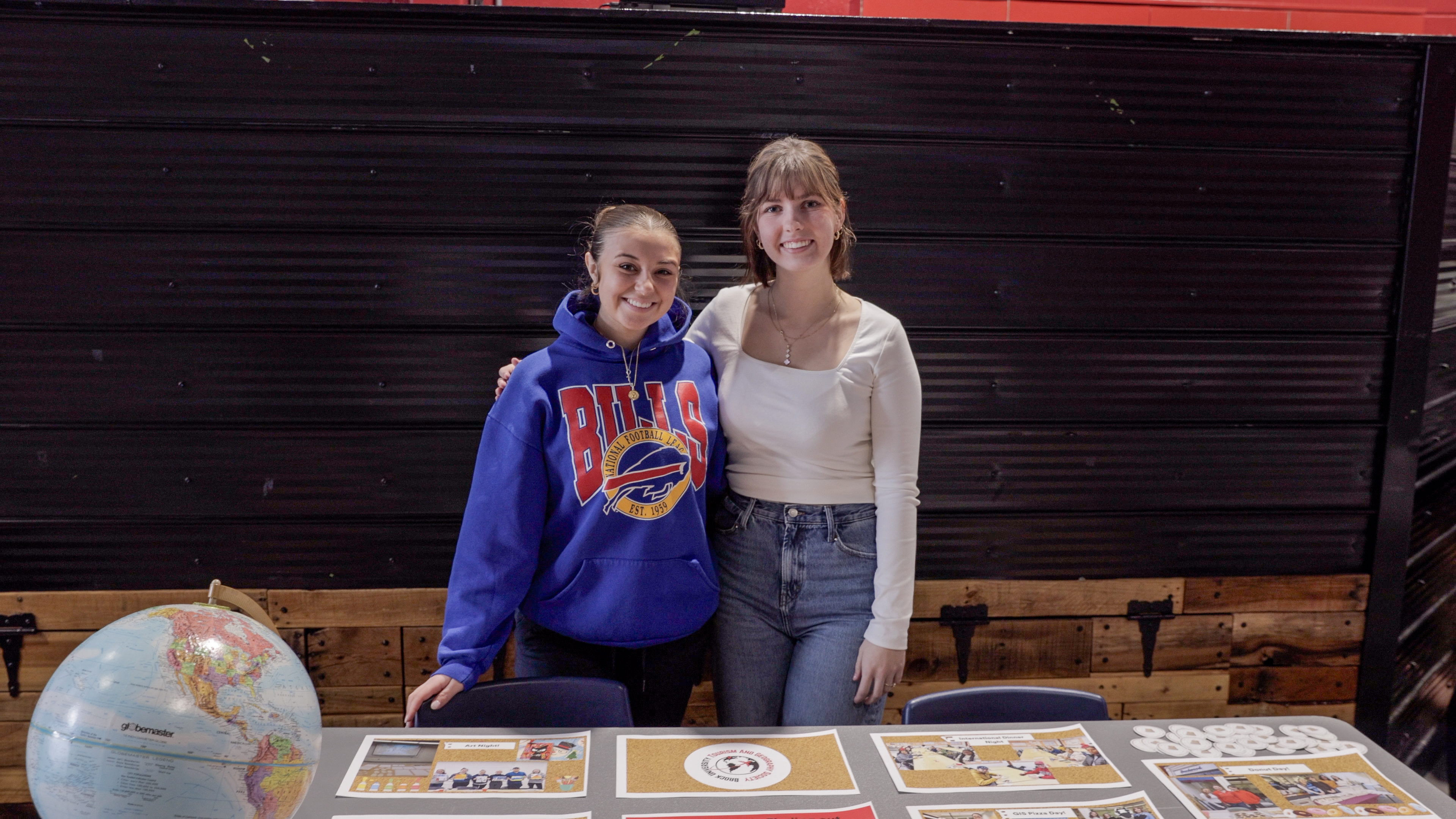 Two BUSU club members during a club event, posing for the camera
