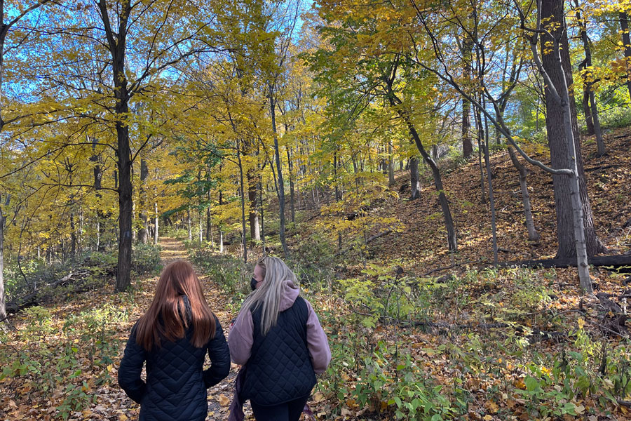 two students walking on the Bruce trail behind Brock University campus